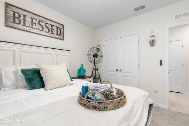 bedroom featuring light carpet and a closet