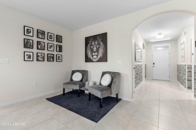 sitting room with light tile patterned floors