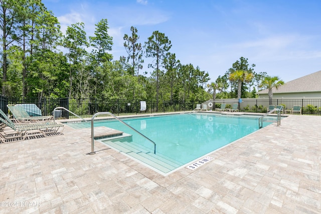 view of swimming pool featuring a patio area