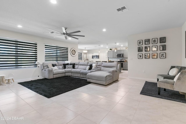 tiled living room featuring ceiling fan