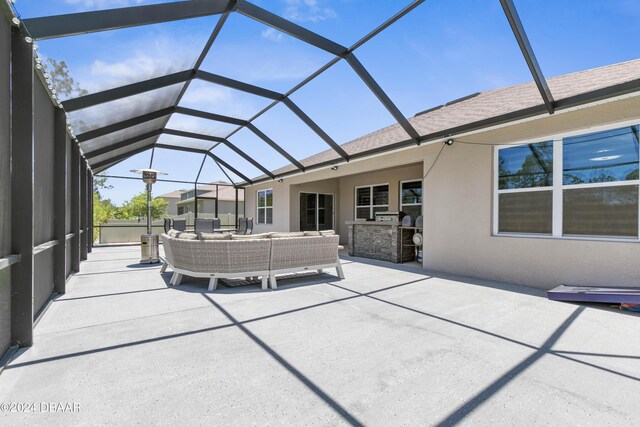 view of patio featuring outdoor lounge area, area for grilling, and glass enclosure