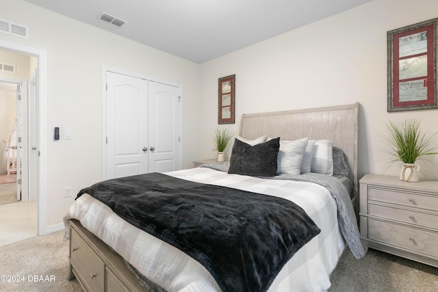 bedroom with light carpet and a closet