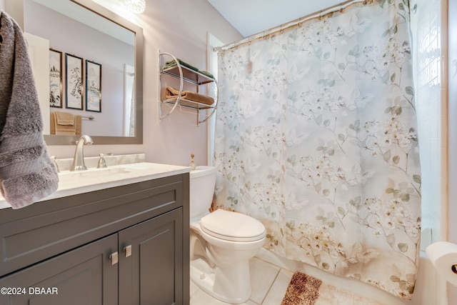 bathroom with toilet, a shower with curtain, vanity, and tile patterned floors