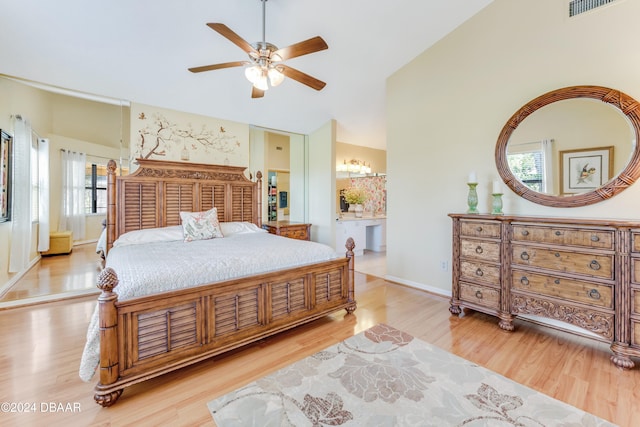 bedroom with multiple windows, ceiling fan, high vaulted ceiling, and light hardwood / wood-style floors