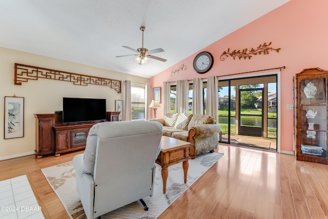 living room with light hardwood / wood-style flooring, ceiling fan, and a healthy amount of sunlight