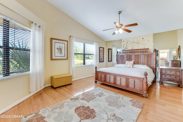 bedroom featuring ceiling fan, light hardwood / wood-style flooring, and lofted ceiling