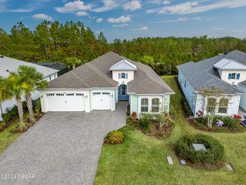 view of front of property with a front lawn and a garage