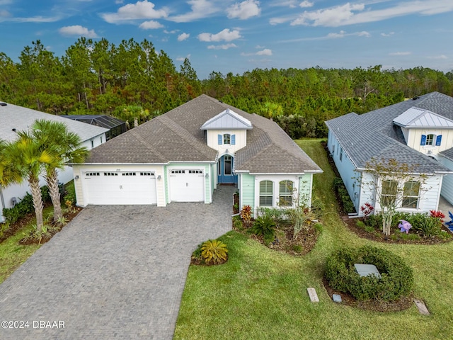 view of front of property with a front lawn and a garage