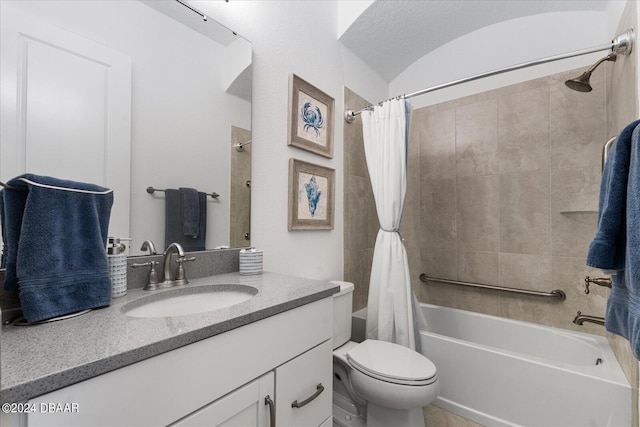 full bathroom with toilet, shower / bath combo, vanity, and a textured ceiling