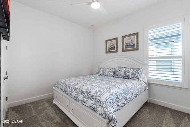 bedroom featuring ceiling fan and dark colored carpet