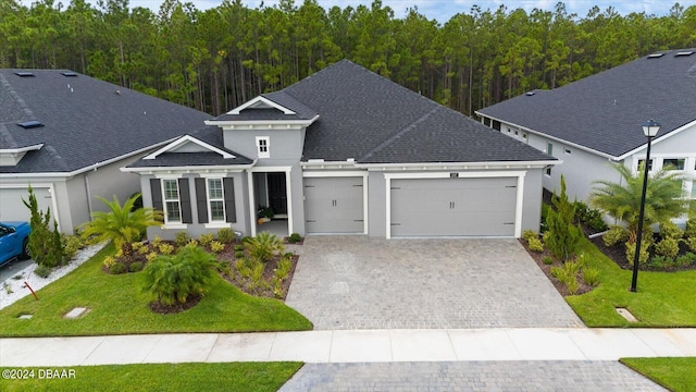 view of front of house with a garage and a front lawn