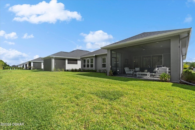 back of house featuring a sunroom and a yard