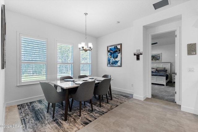 dining space featuring an inviting chandelier