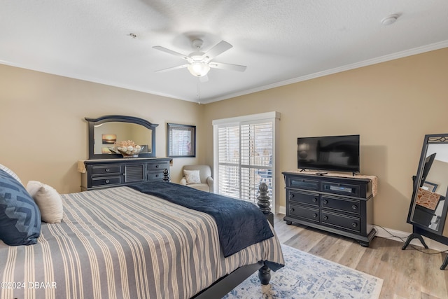 bedroom featuring a textured ceiling, light hardwood / wood-style flooring, ceiling fan, and ornamental molding