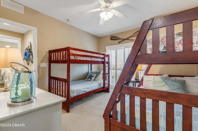 bedroom with light carpet and ceiling fan