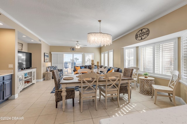 dining area featuring a textured ceiling, ceiling fan with notable chandelier, light tile patterned floors, and crown molding