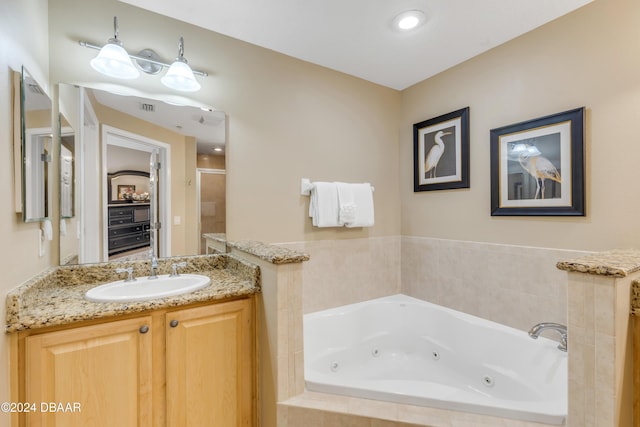 bathroom with vanity and independent shower and bath