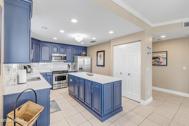 kitchen featuring blue cabinetry, a kitchen island, stainless steel appliances, and tasteful backsplash