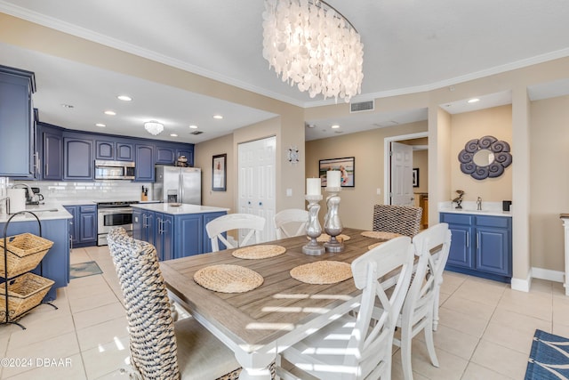 tiled dining space with crown molding, sink, and a notable chandelier