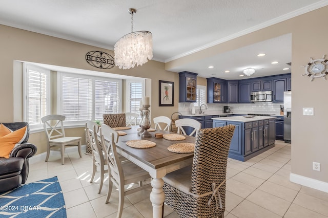 dining area with plenty of natural light, light tile patterned flooring, ornamental molding, and an inviting chandelier