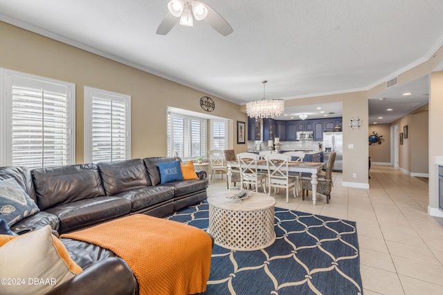 tiled living room featuring ceiling fan with notable chandelier and crown molding