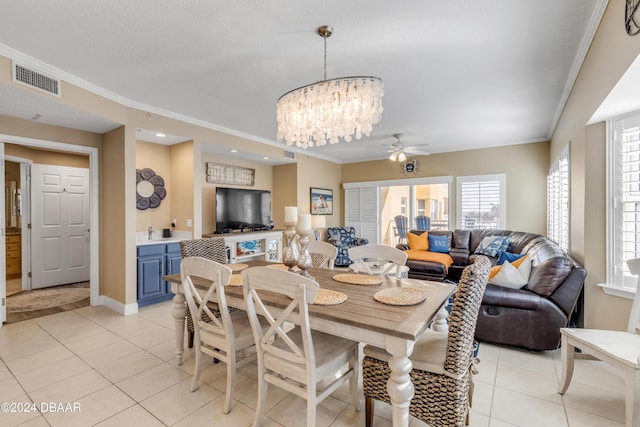 tiled dining space with crown molding and ceiling fan with notable chandelier