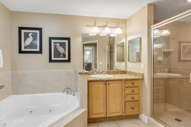 bathroom with tile patterned flooring, vanity, and separate shower and tub