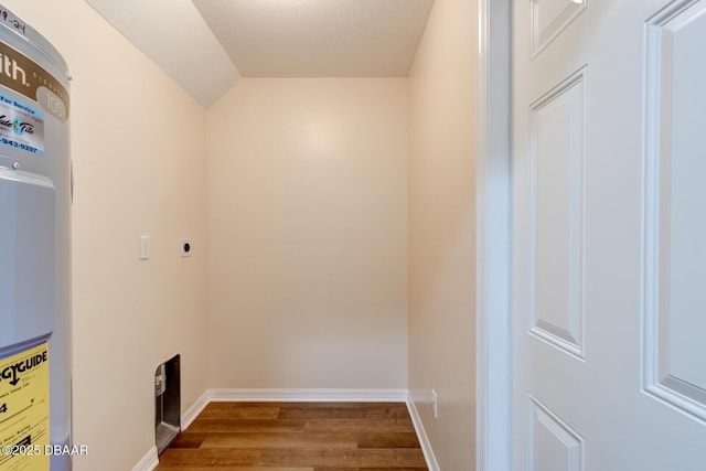 laundry area with water heater and wood-type flooring