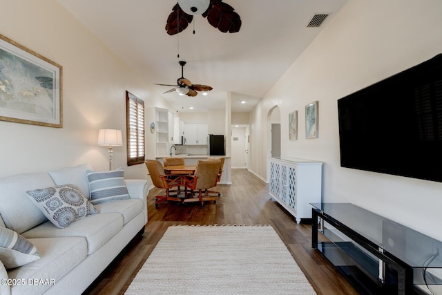 living room with dark hardwood / wood-style floors and ceiling fan