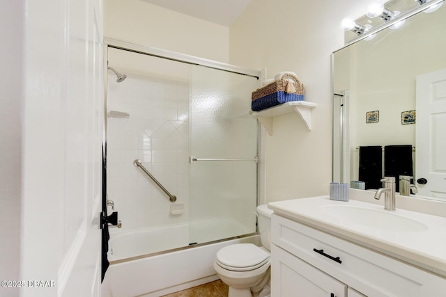 full bathroom featuring vanity, combined bath / shower with glass door, and toilet