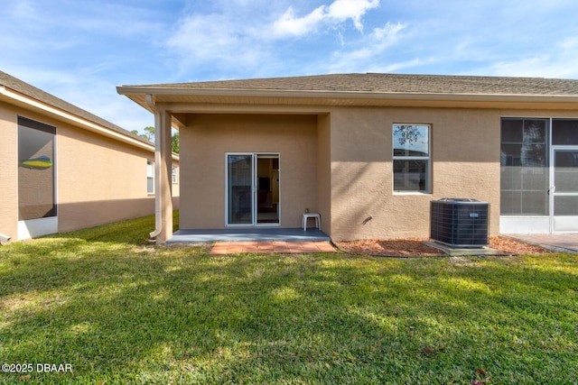 rear view of house featuring a yard, a patio area, and central air condition unit