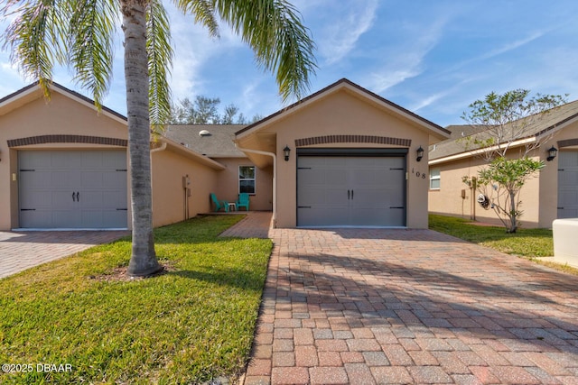 ranch-style home with a garage and a front lawn