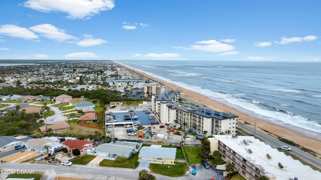 birds eye view of property with a beach view and a water view