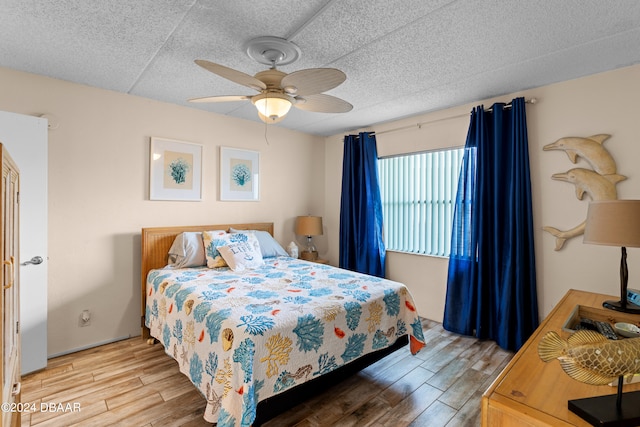 bedroom with light wood-type flooring and ceiling fan