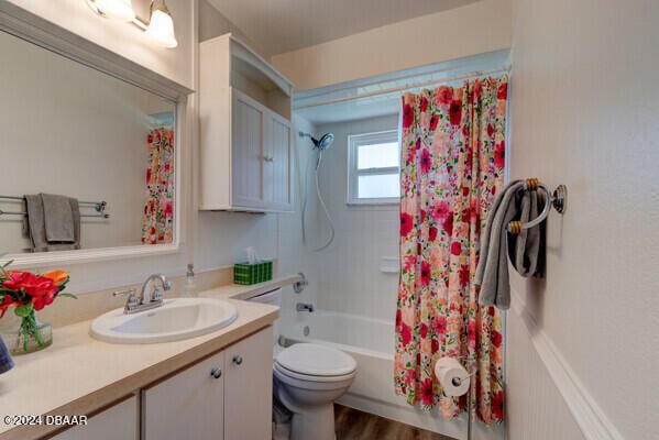 full bathroom with shower / bath combo, vanity, toilet, and hardwood / wood-style floors