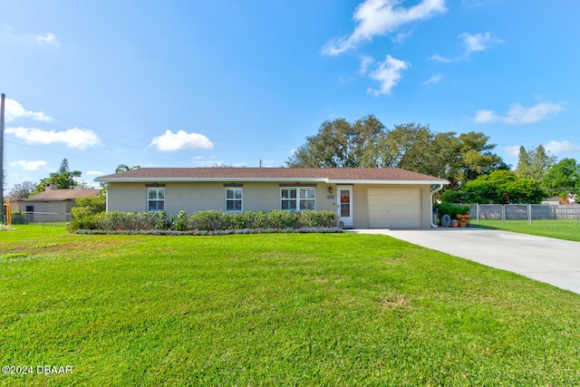 ranch-style home with a front yard and a garage