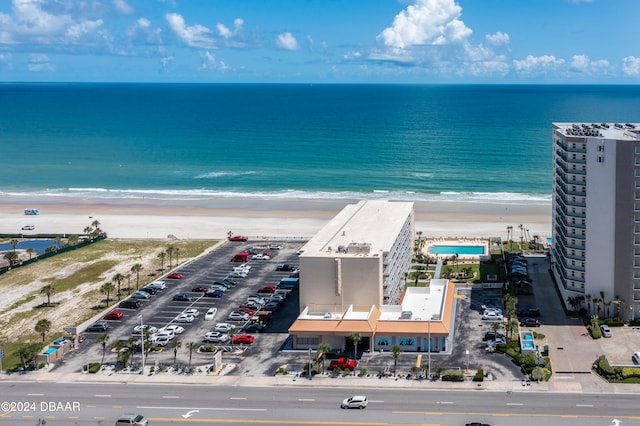 aerial view with a water view and a beach view