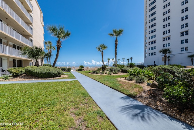 view of property's community with a lawn