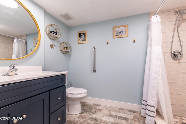 bathroom featuring toilet, vanity, and a shower with shower curtain