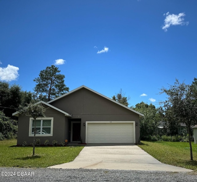 view of front of home featuring a garage and a front lawn