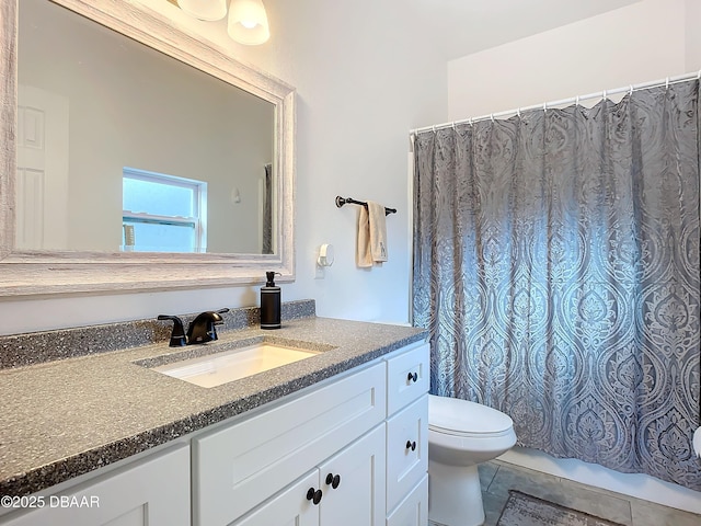 bathroom with tile patterned flooring, vanity, and toilet