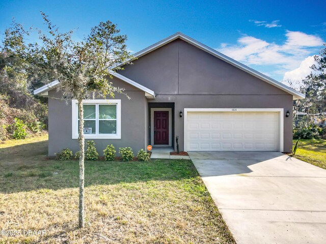 view of front of property with a garage and a front yard