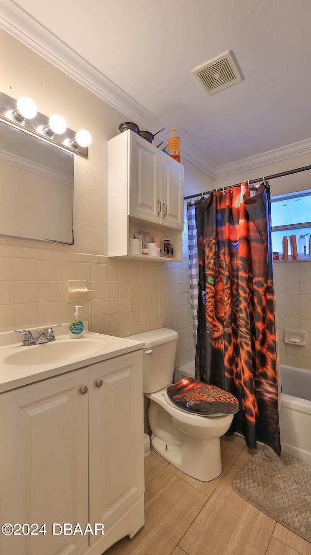 full bathroom featuring ornamental molding, tile walls, shower / bath combo, and toilet