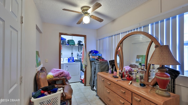 bedroom with washing machine and dryer, ceiling fan, a textured ceiling, and light tile patterned floors