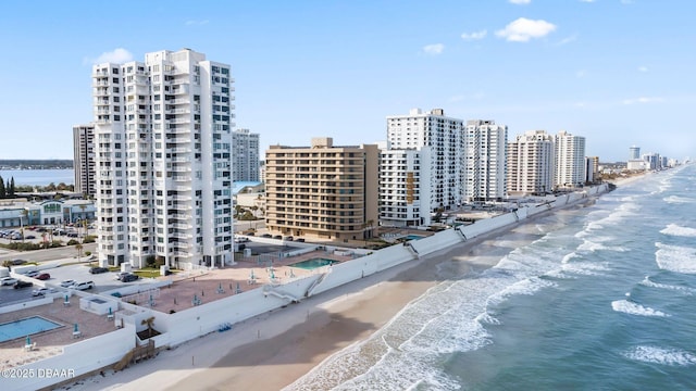 birds eye view of property with a view of city, a beach view, and a water view