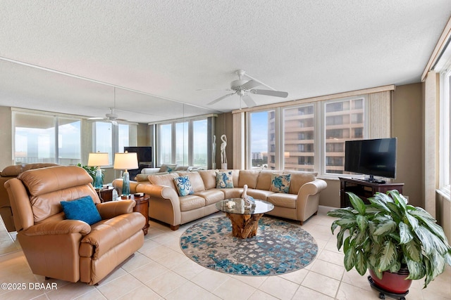 living room featuring light tile patterned floors, plenty of natural light, and ceiling fan