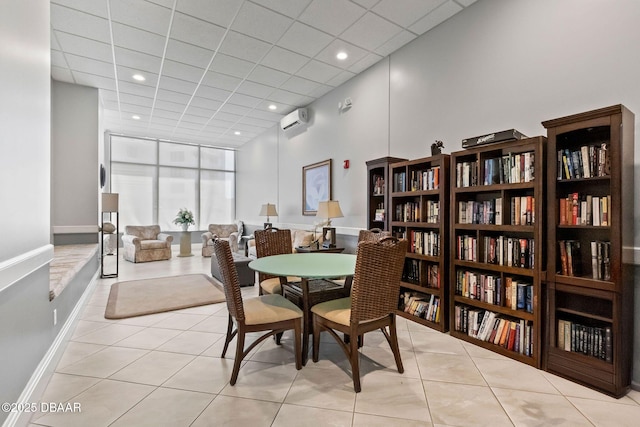 dining area with light tile patterned flooring, recessed lighting, a towering ceiling, baseboards, and a wall mounted AC