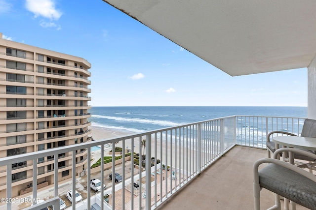 balcony with a beach view and a water view