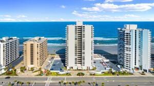 birds eye view of property with a water view and a city view