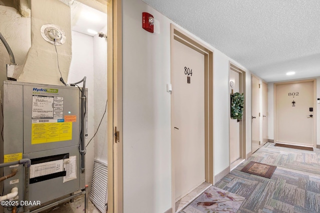 interior space with a textured ceiling and baseboards